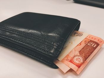 Close-up of indian currency in wallet on table