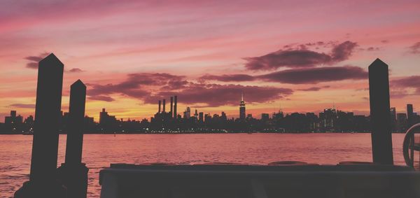 Scenic view of silhouette buildings against sky during sunset