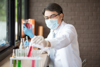 Man examining test tube in laboratory