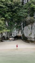 Rear view of woman walking on beach