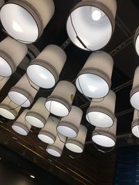 Low angle view of illuminated pendant lights hanging from ceiling