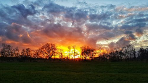 Scenic view of field against sky during sunset