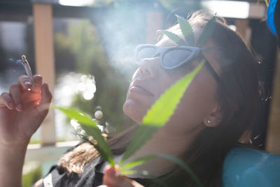 Close-up of woman holding cigarette