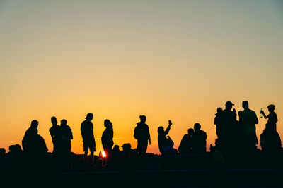 Silhouette people at sunset