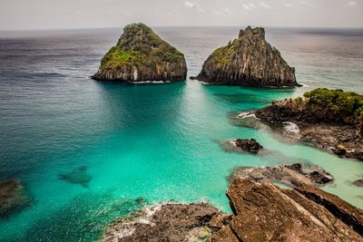 Panoramic view of rocks on sea against sky