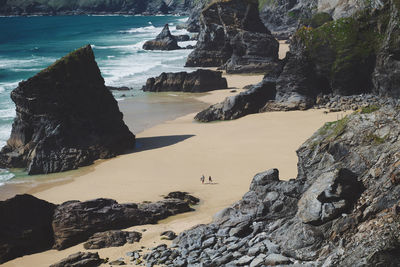 Rock formation on beach against sky at bedruthan steps