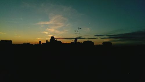 Silhouette built structures at sunset