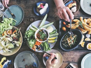 Cropped hands having food on table