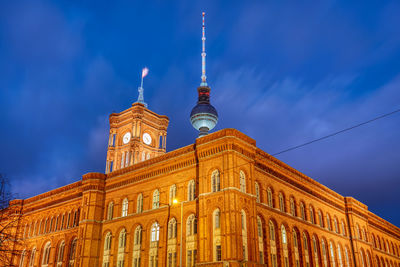 The berlin city hall with the famous television tower in the back at night