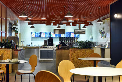 Empty chairs and tables in restaurant