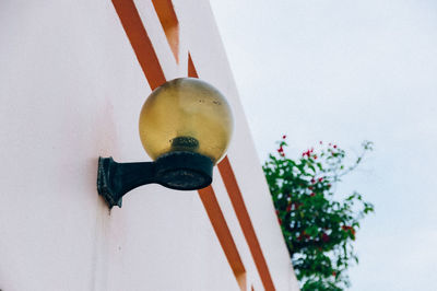 Low angle view of decoration hanging against white wall