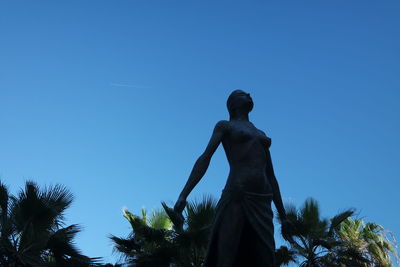 Low angle view of statue against clear blue sky