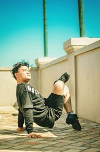 Side view of young man dancing on terrace