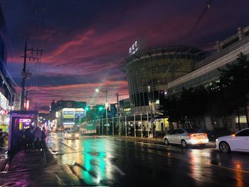 Cars on illuminated street at night