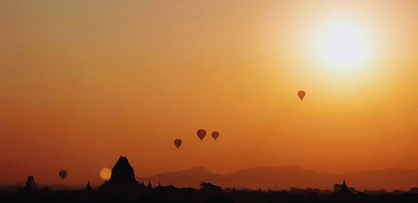 Silhouette of hot air balloon against sky during sunset