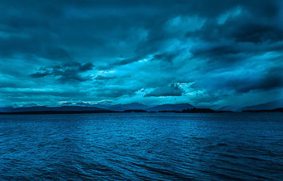 Scenic view of sea against storm clouds