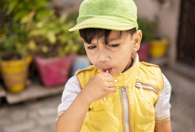 Portrait of cute boy standing outdoors