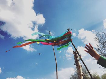 Low angle view of flags hanging against sky