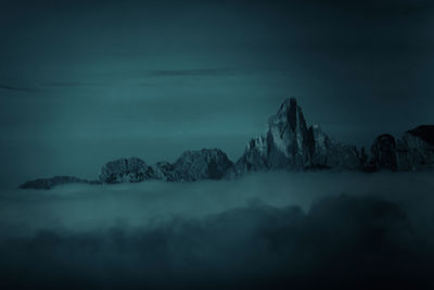 Silhouette trees in forest against sky at night