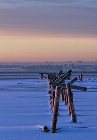 Pier on sea at sunset