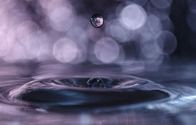 Close-up of water drop on glass table