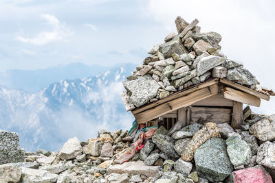 Stack of rocks against sky during winter