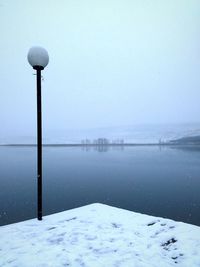 Scenic view of lake against sky during winter