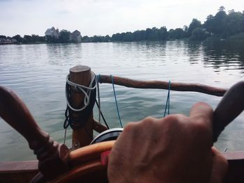 Midsection of man on boat in lake