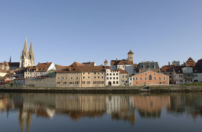 Buildings in city against clear sky