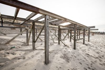 Built structure on beach against clear sky during winter