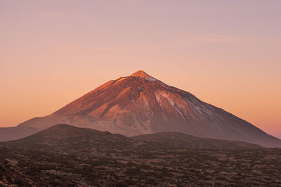 Scenic view of volcanic mountain during sunset
