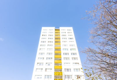 Low angle view of buildings against clear blue sky