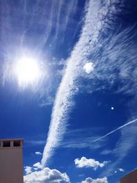 Low angle view of vapor trail against blue sky