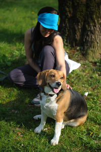 Rear view of man with dog on field