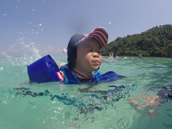 Close-up of boy swimming in sea