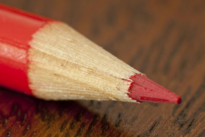 Close-up of red pencils on table