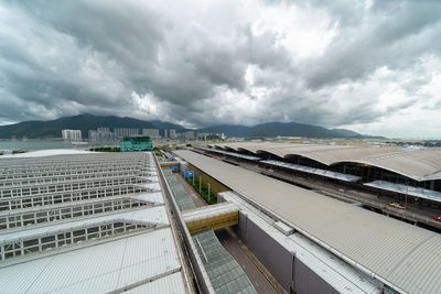 Aerial view of city against cloudy sky