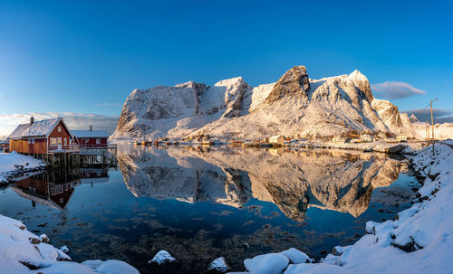 Scenic view of snowcapped mountains against blue sky