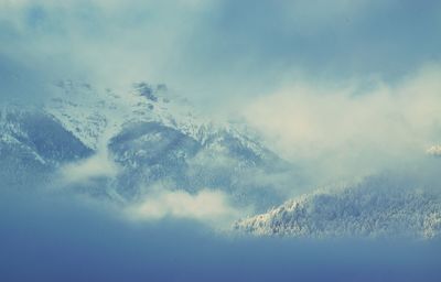 Aerial view of snow covered mountains against sky