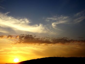 Low angle view of silhouette landscape against sky during sunset