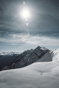 Scenic view of snowcapped mountains against sky