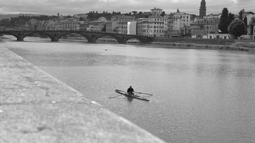 People on bridge over river