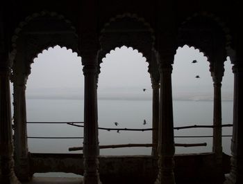 Looking through historical indian temple archs at ganges