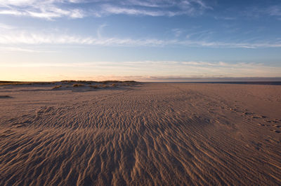 Scenic view of beach against sky during sunset