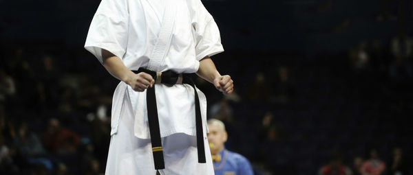 Midsection of boy wearing karate uniform