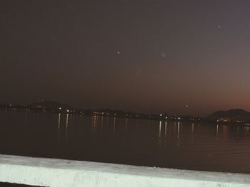 Scenic view of sea against sky during winter at night