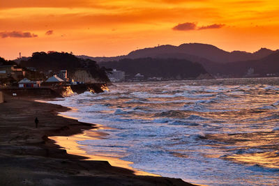 Scenic view of sea against orange sky