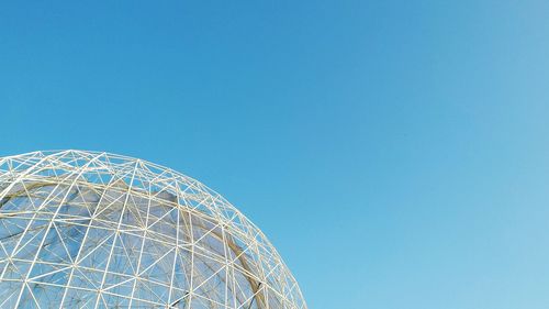 Low angle view of trees against clear blue sky