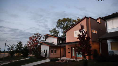 Low angle view of building and trees against sky