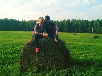 Friends on field against sky